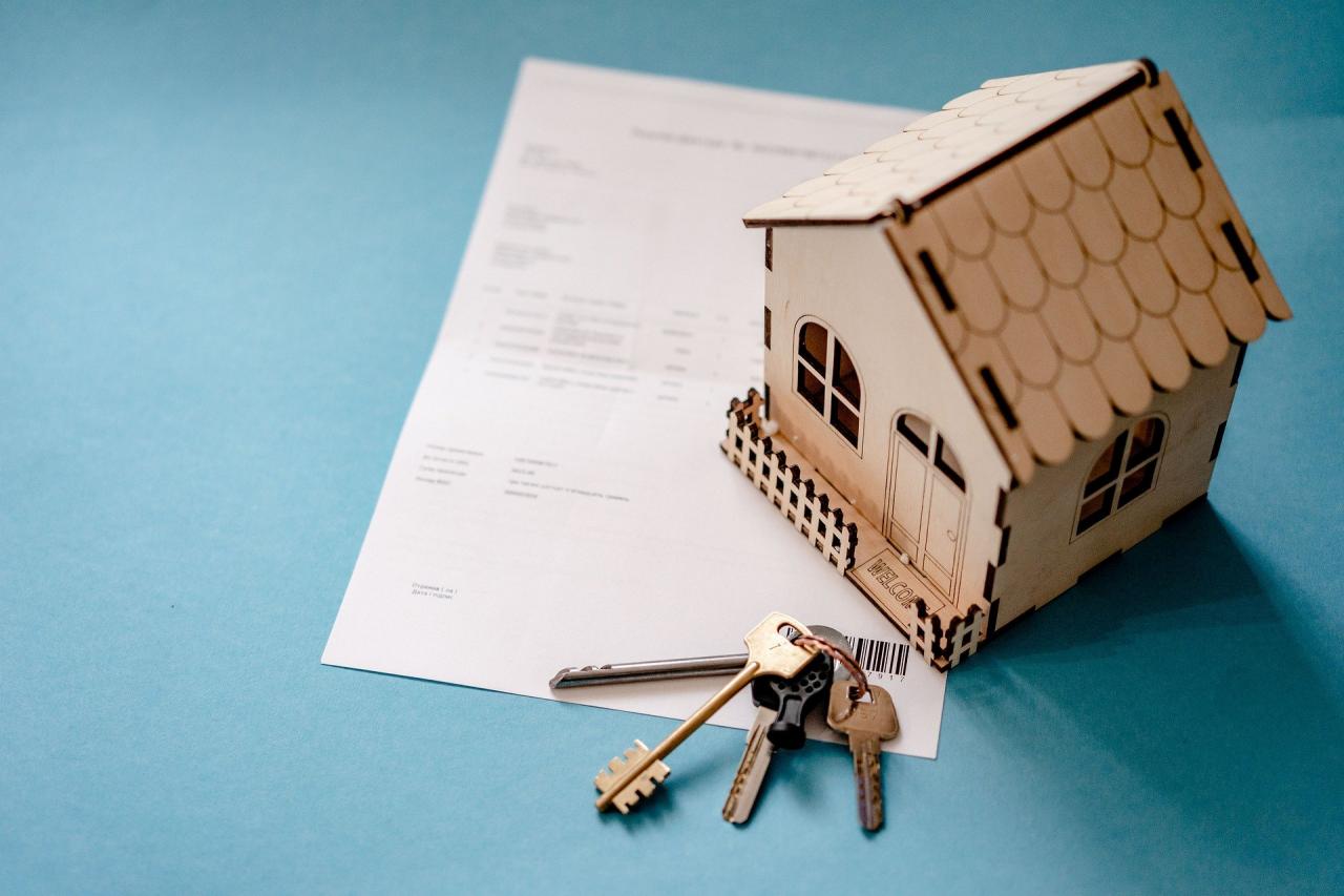 image of a model of a wooden house being used as a paperweight