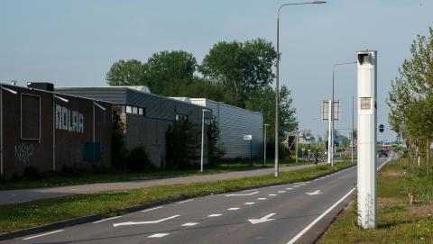 Image of a nondescript road with a speed camera on it courtesy of unsplash and the photographer haberdoedas ii