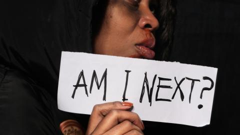 Image of bruised woman holding up a sign courtetsy of Musa Artful from Pexels